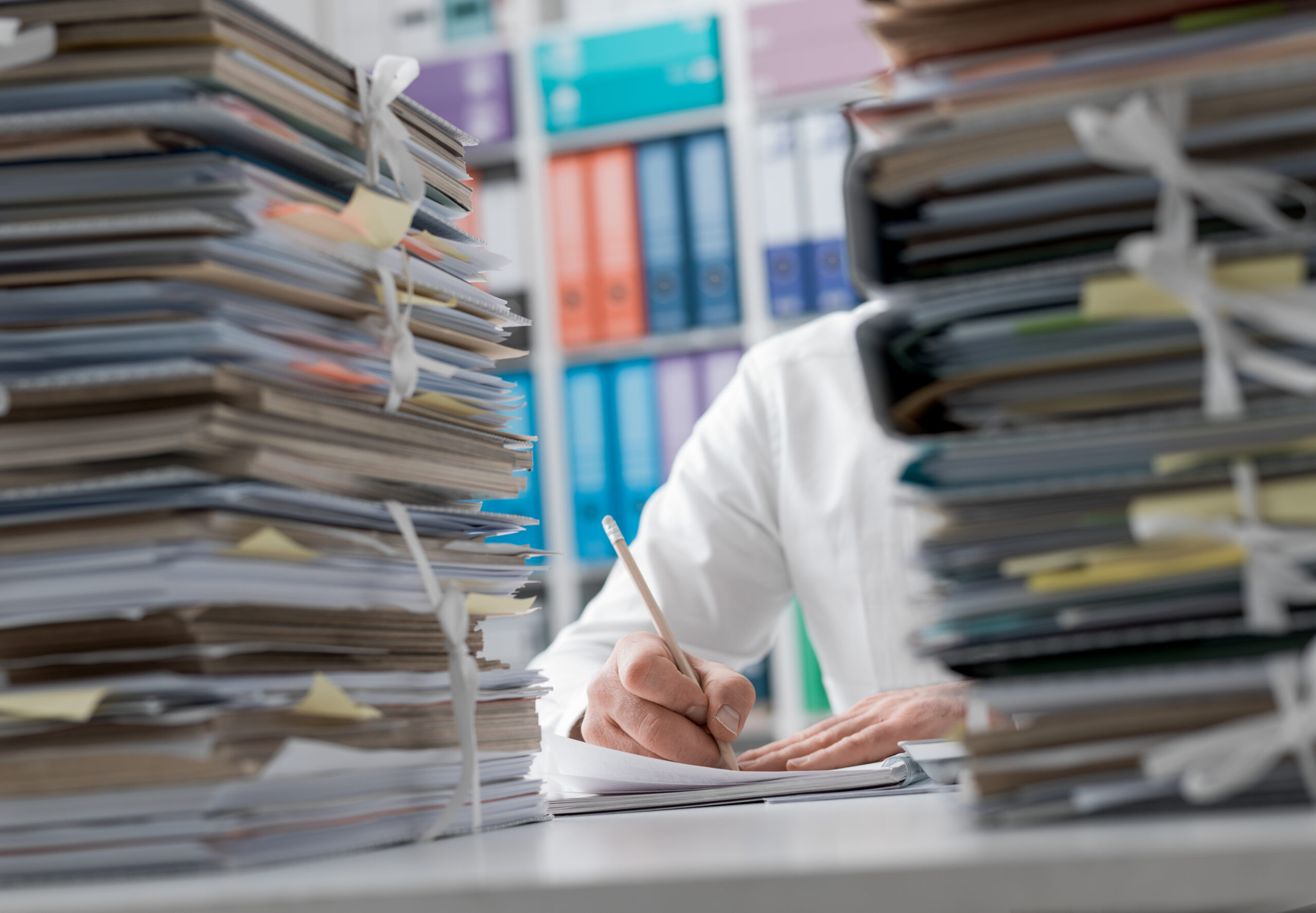 business,executive,working,in,the,office,and,piles,of,paperwork,